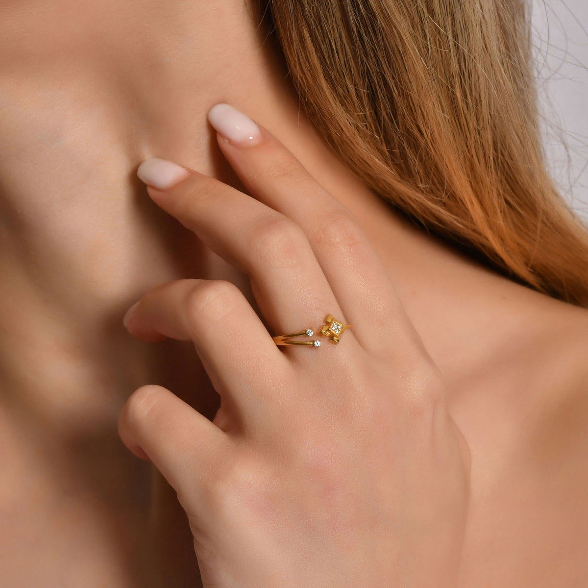 18K gold open geometric diamond ring on raised hand