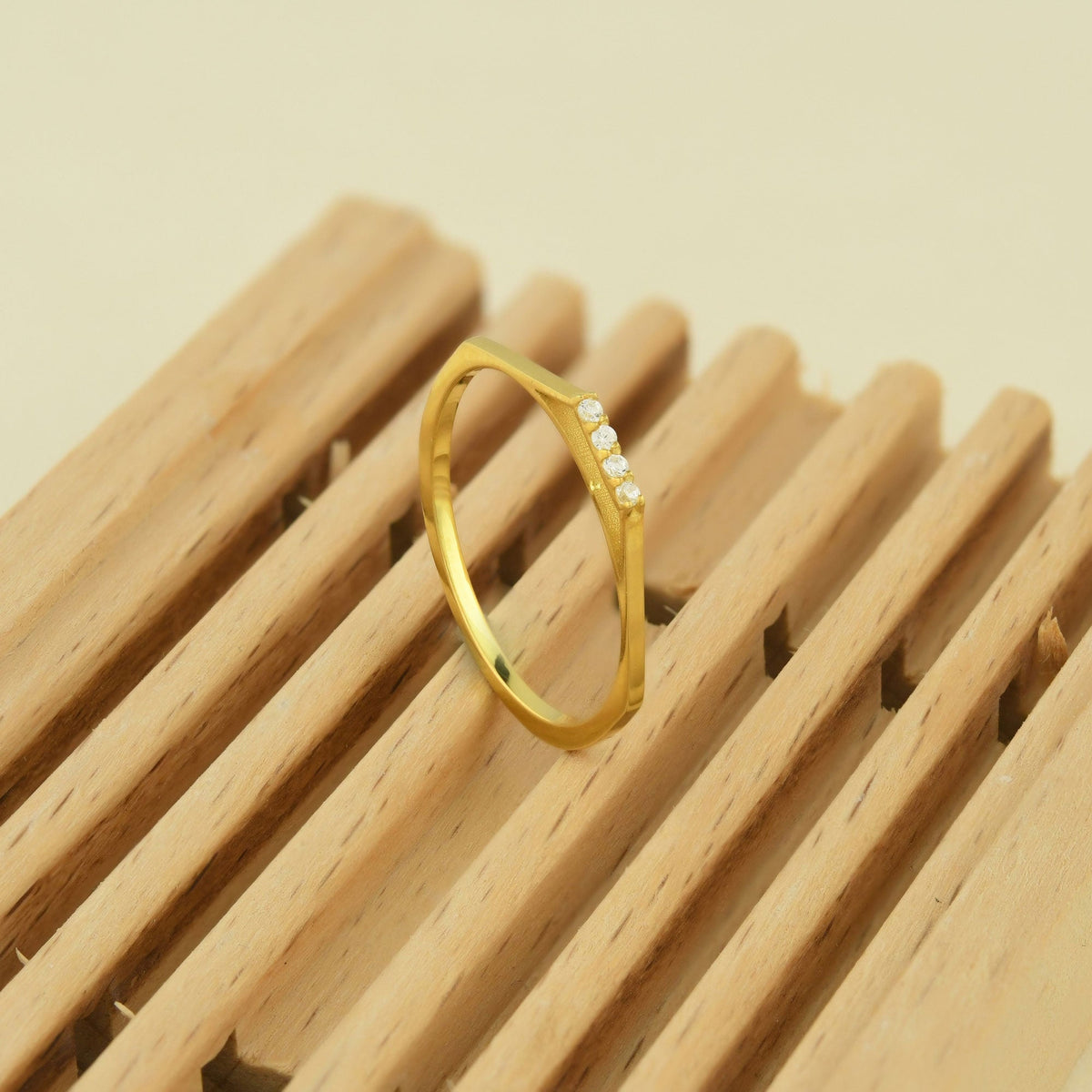 10K gold mini bar cubic zirconia ring on display