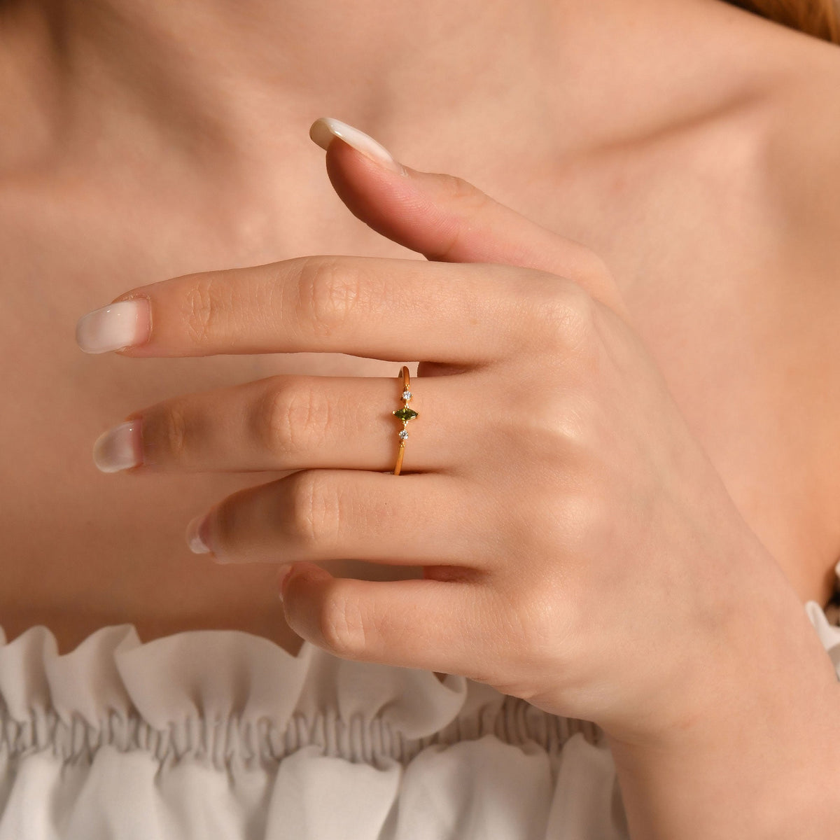 18K gold green-stone marquise diamond ring worn on hand
