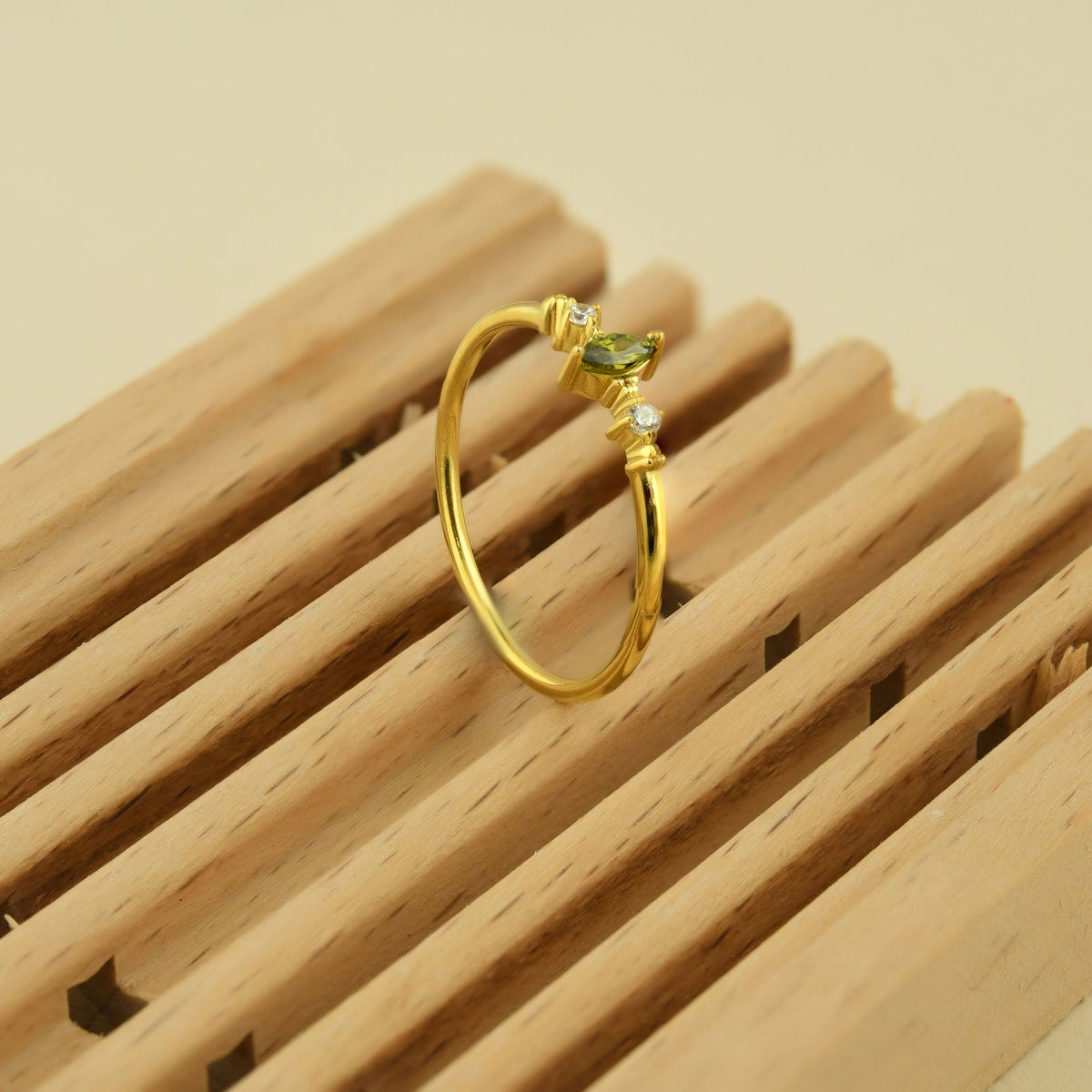 10K gold green-stone marquise diamond ring on display