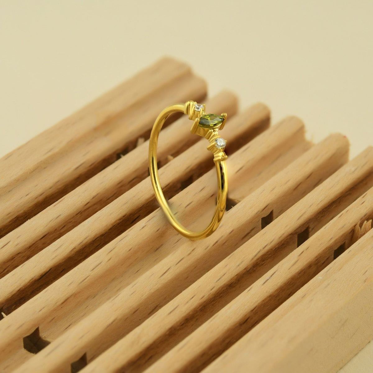 18K gold green-stone marquise cubic zirconia ring on display