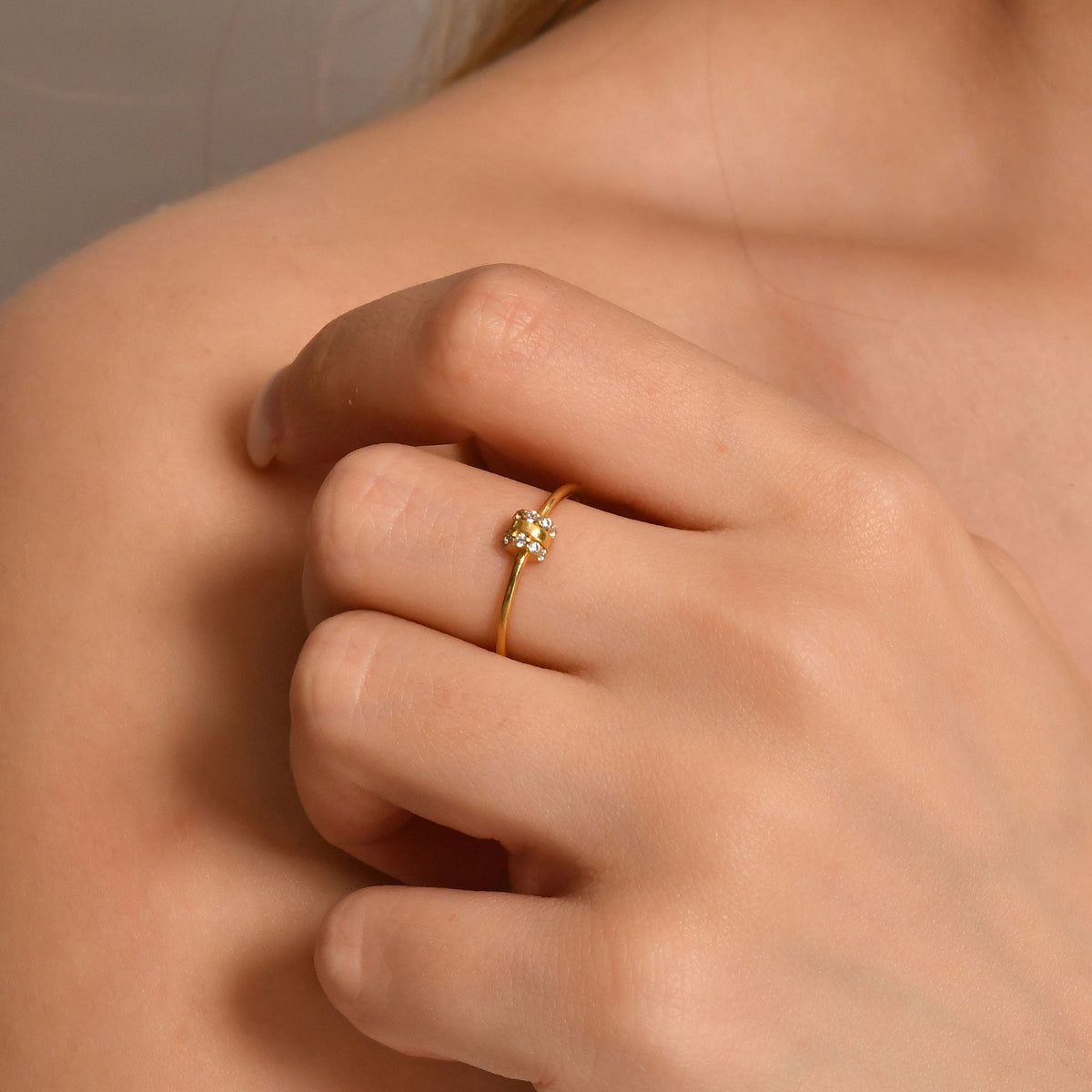 10K gold vertical bar cubic zirconia ring on raised hand