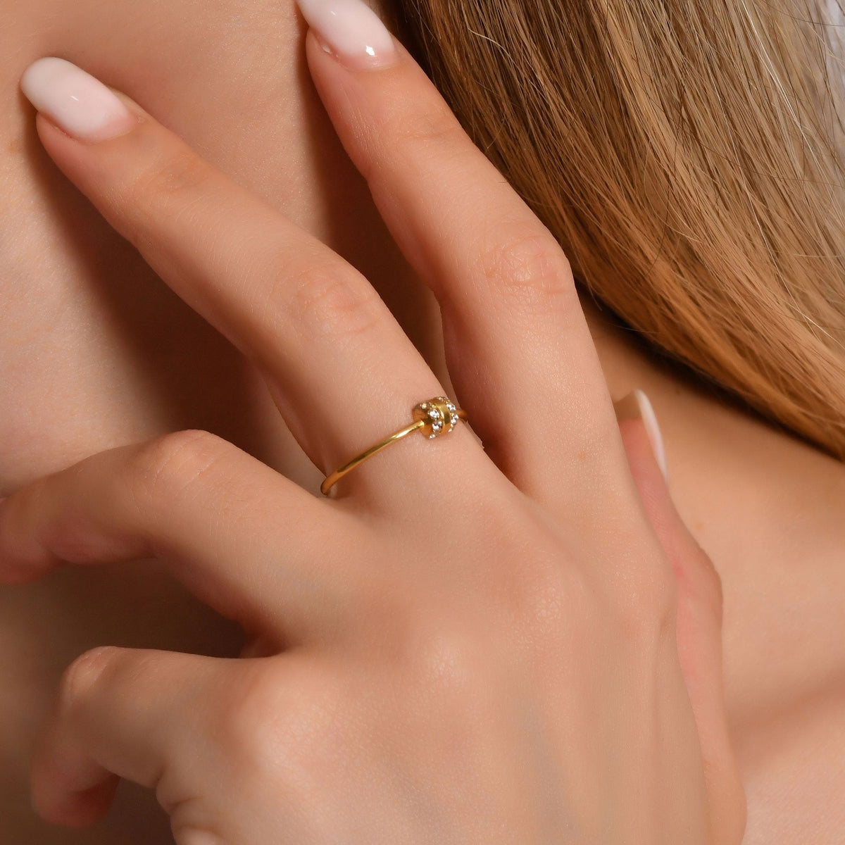 18K gold vertical bar diamond ring on finger, close-up
