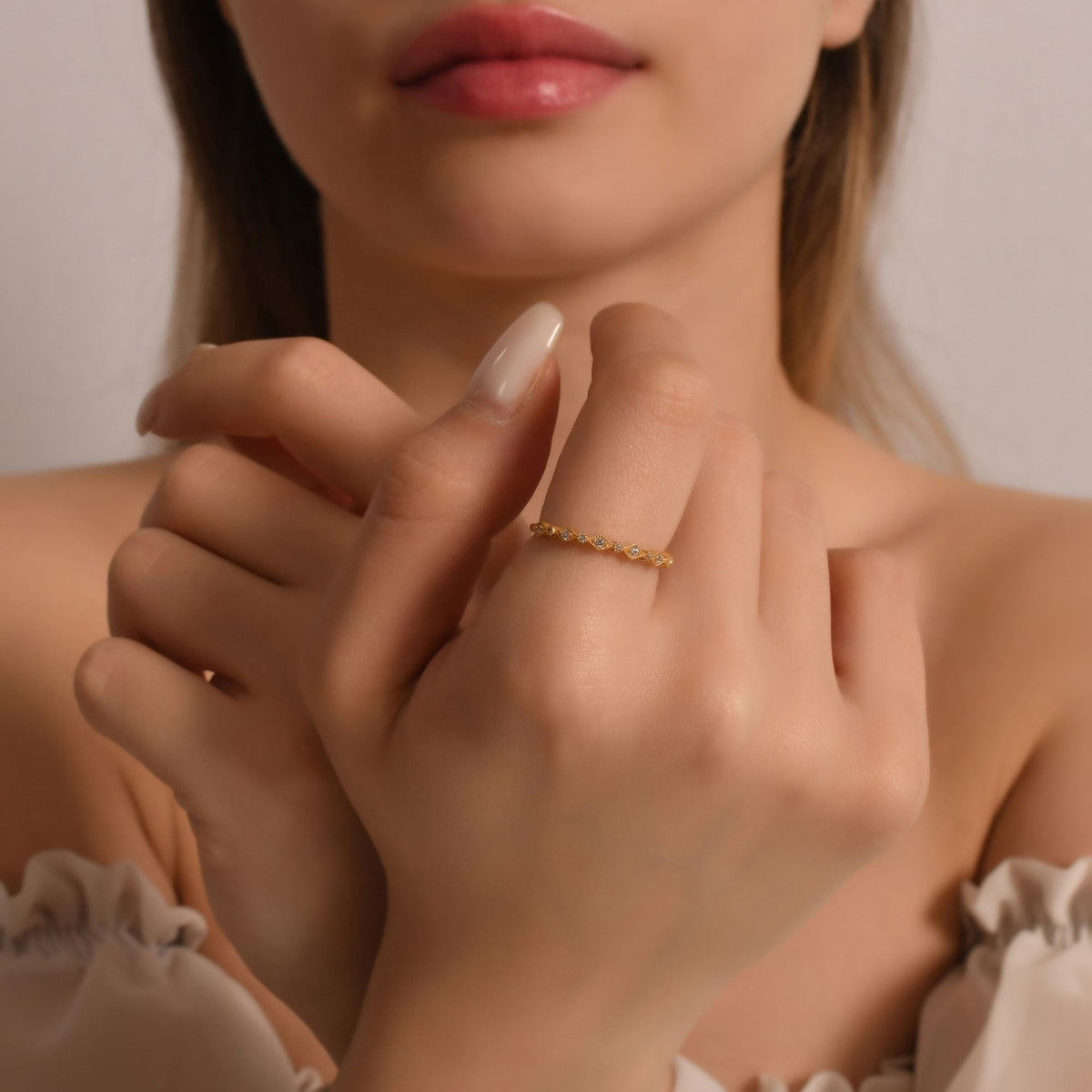 14K gold milgrain stackable diamond ring on finger, close-up