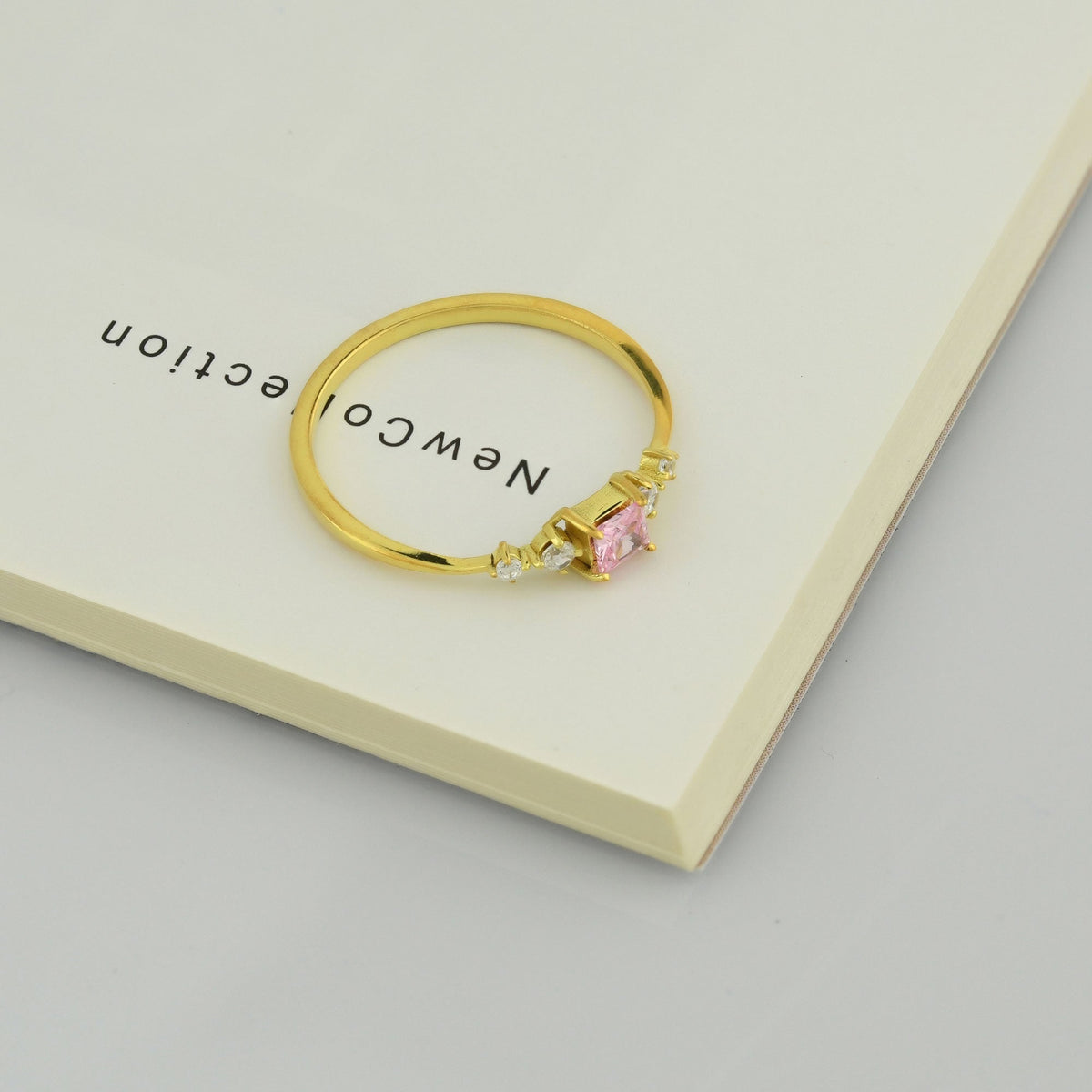 14K gold pink-stone princess cubic zirconia ring on display