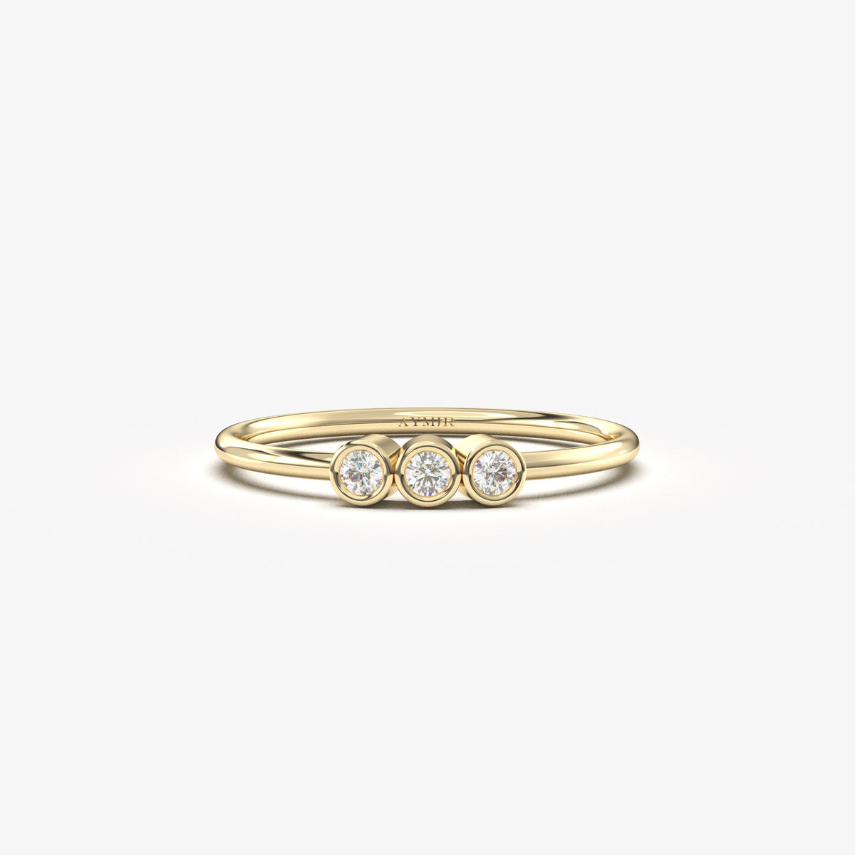 18K yellow gold three stone bezel ring with cubic zirconia, front view