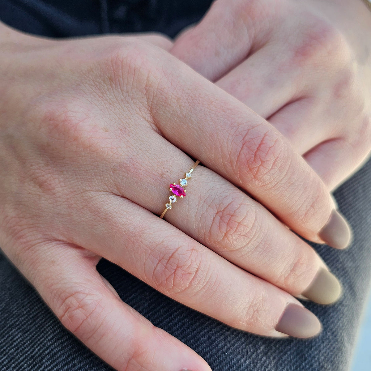 Gold red-stone marquise ring worn on hand