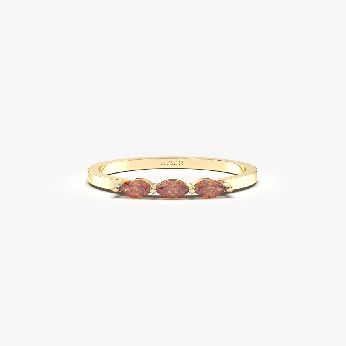 10K yellow gold three stone marquise ring with orange-red marquise stones, front view