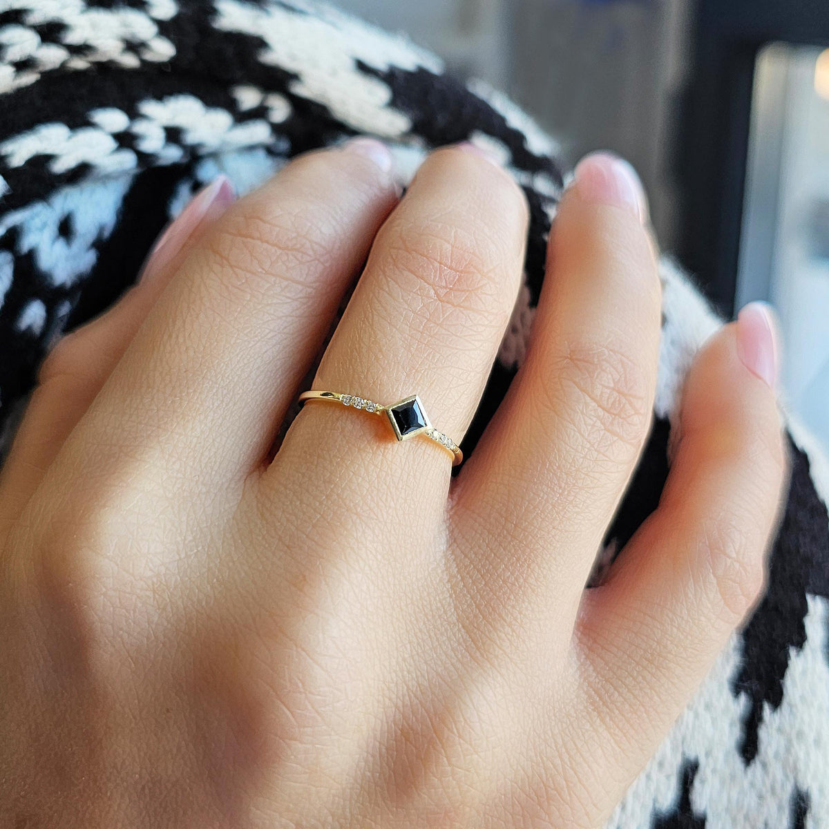 Gold black-stone princess ring worn on hand, close-up