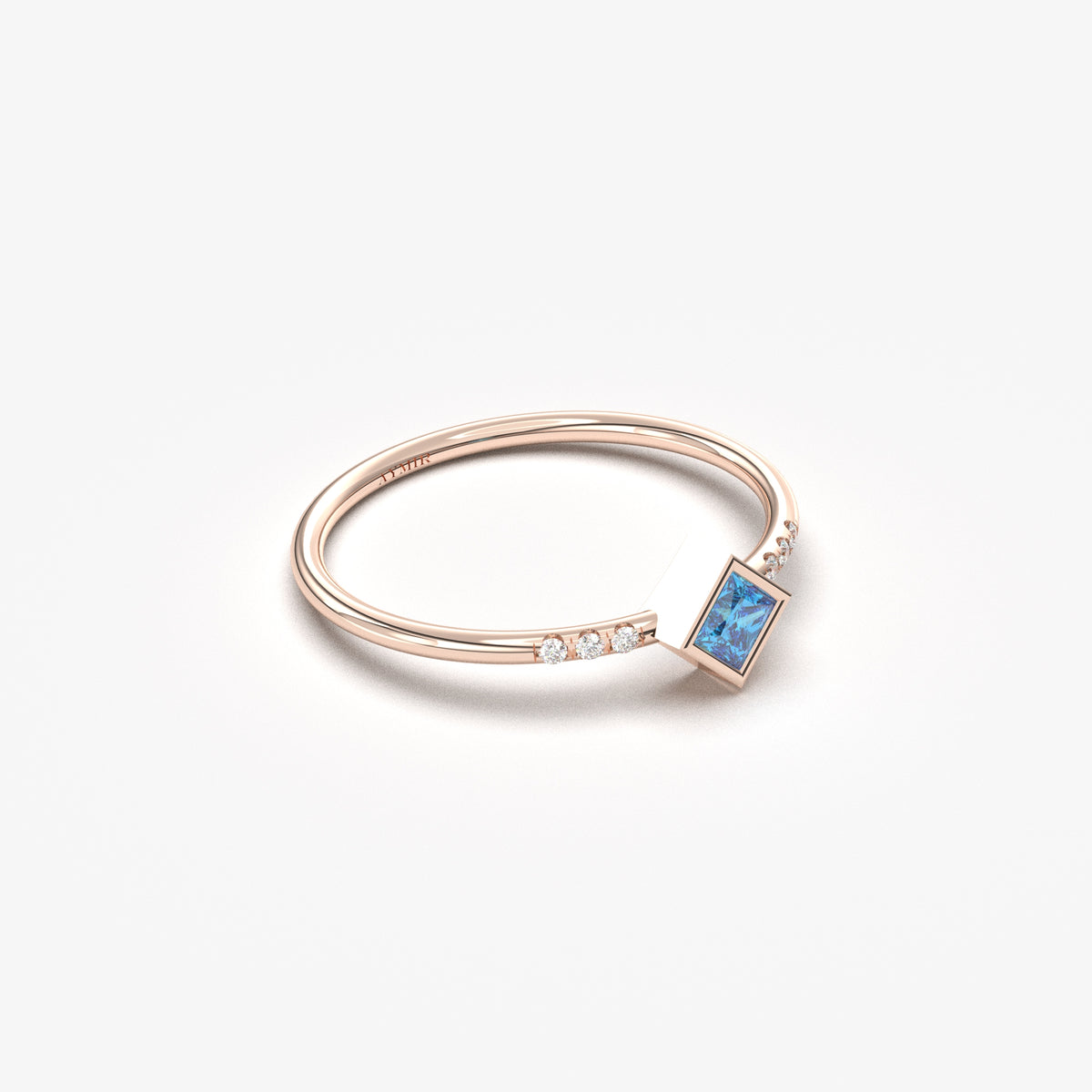 18K rose gold blue-stone princess ring with cubic zirconia, angled view