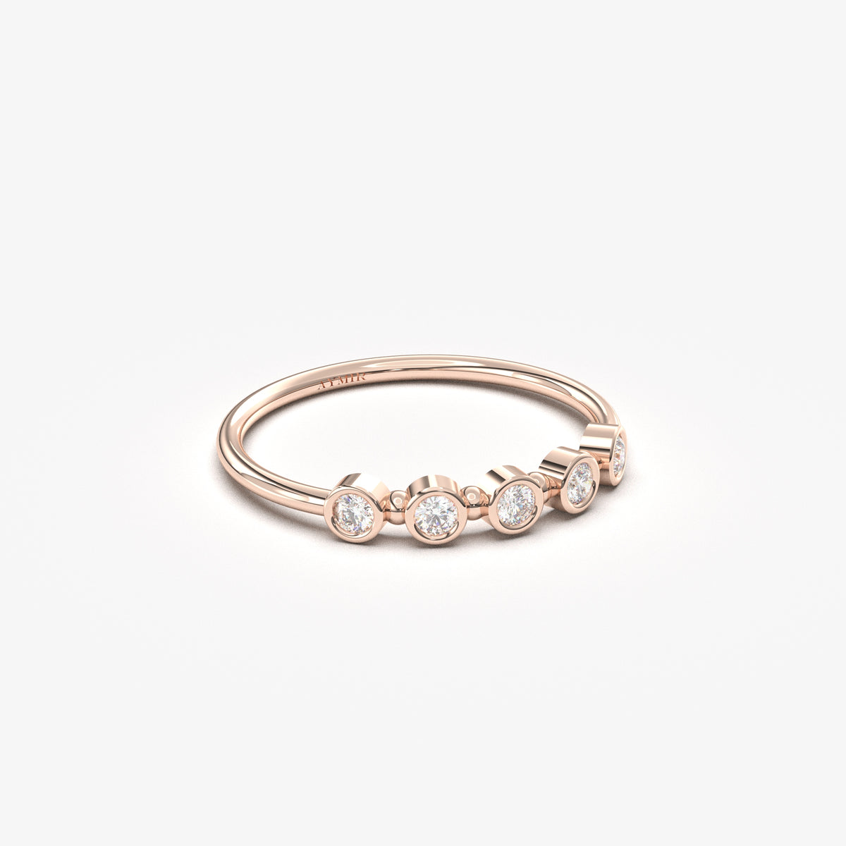 10K rose gold five stone bezel ring with cubic zirconia, angled view