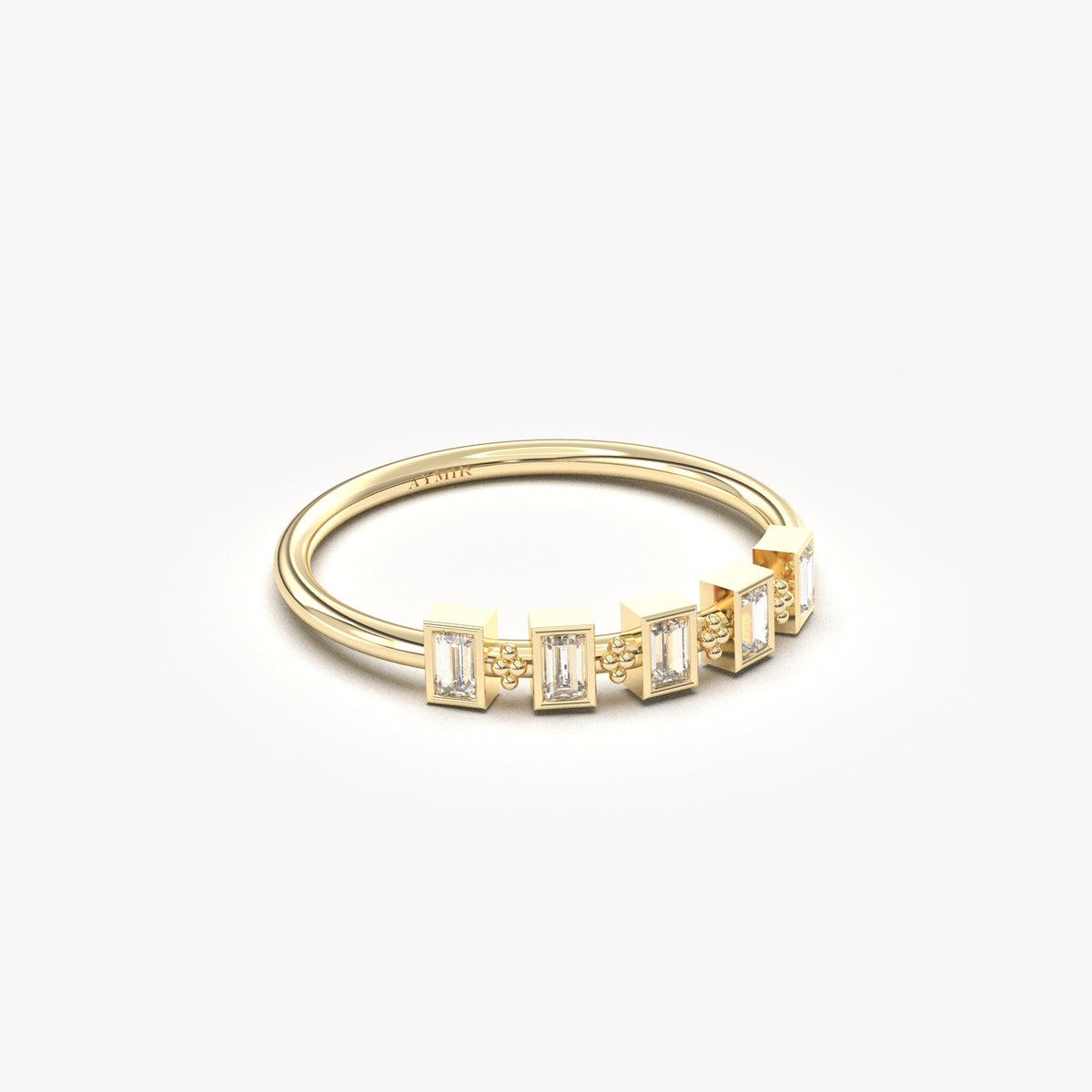 18K yellow gold five baguette bezel ring with cubic zirconia, angled view