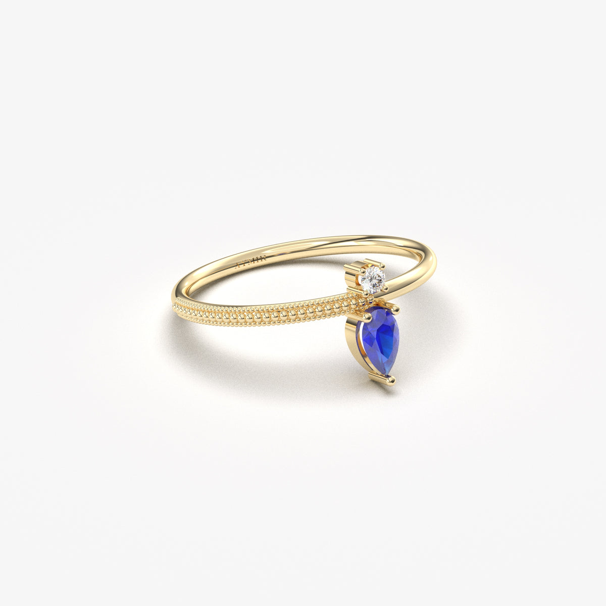 Yellow gold blue-stone pear ring, angled view