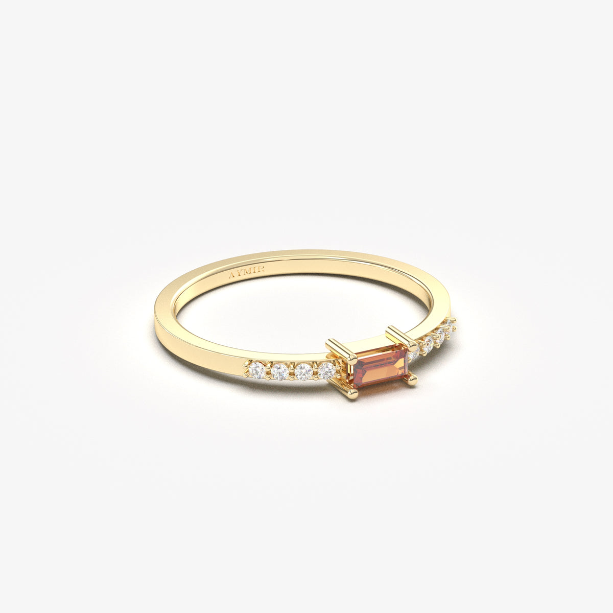 Yellow gold dark-red-stone baguette ring, angled view