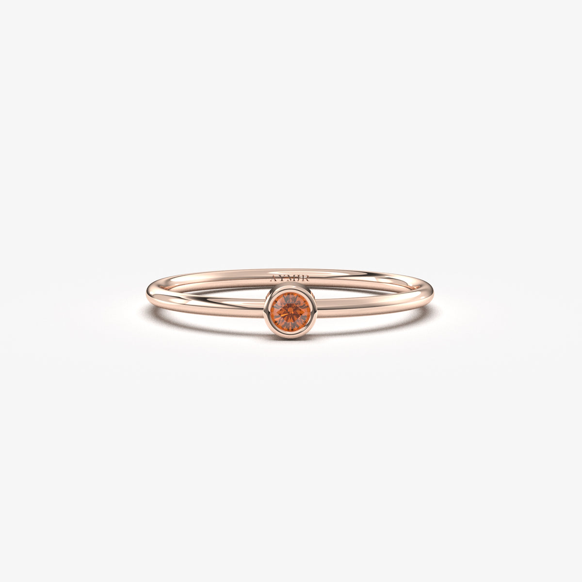 Rose gold dark-red-stone bezel solitaire ring, front view
