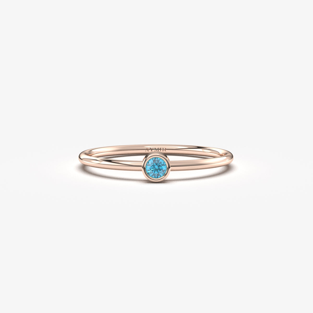 Rose gold light-blue-stone bezel solitaire ring, front view
