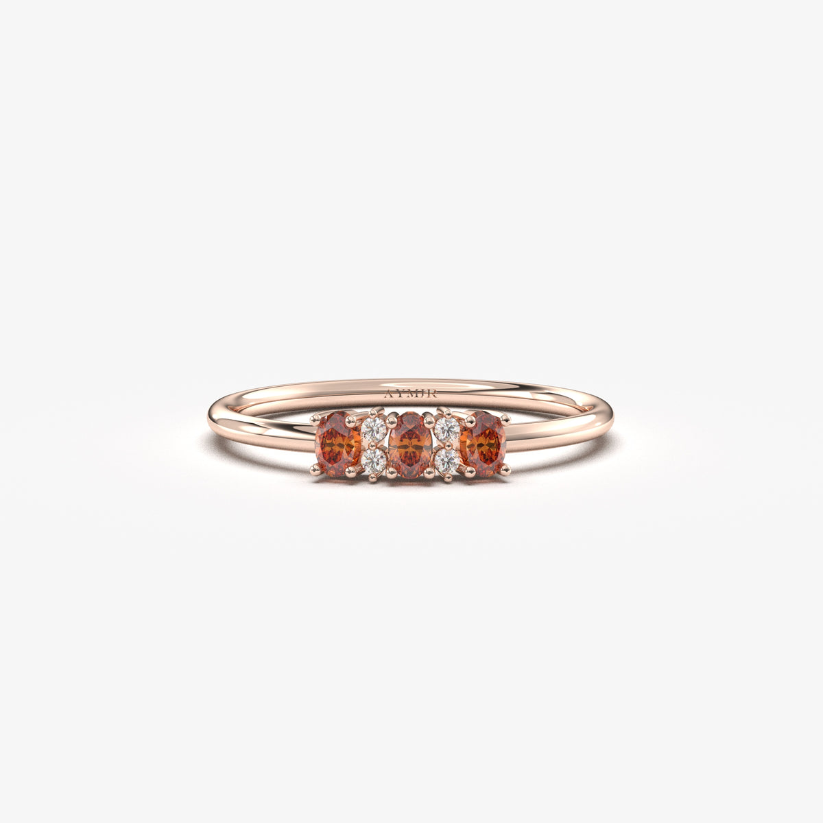 Rose gold dark-red-stone three oval ring, front view