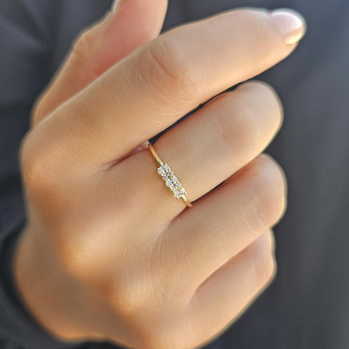 Gold three-oval ring worn on hand, close-up