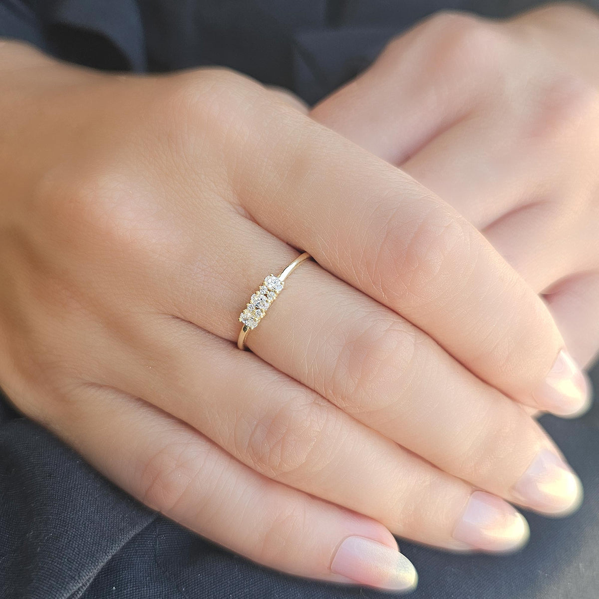 Gold three-oval ring worn on hand