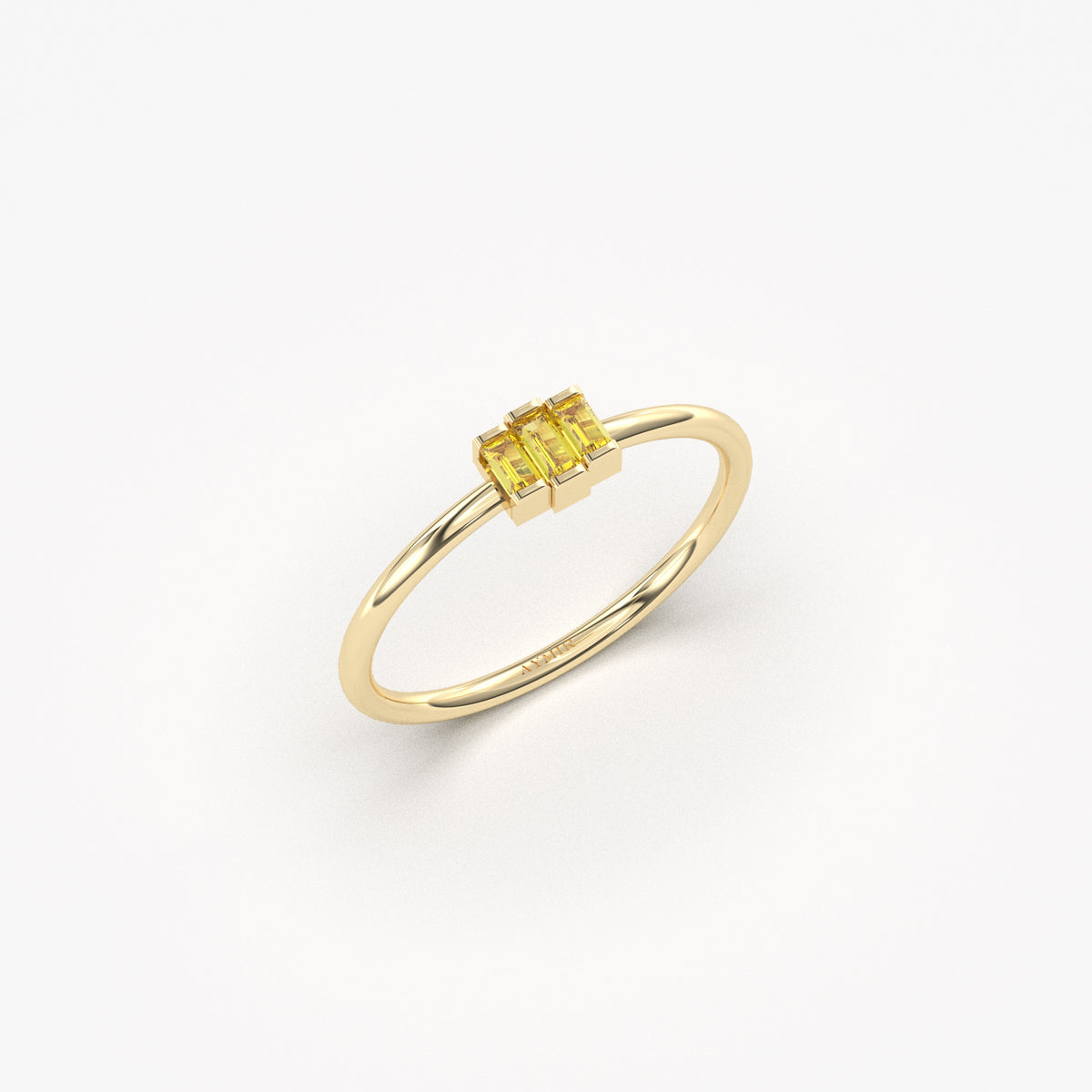 Yellow gold yellow-stone three-baguette ring, angled view