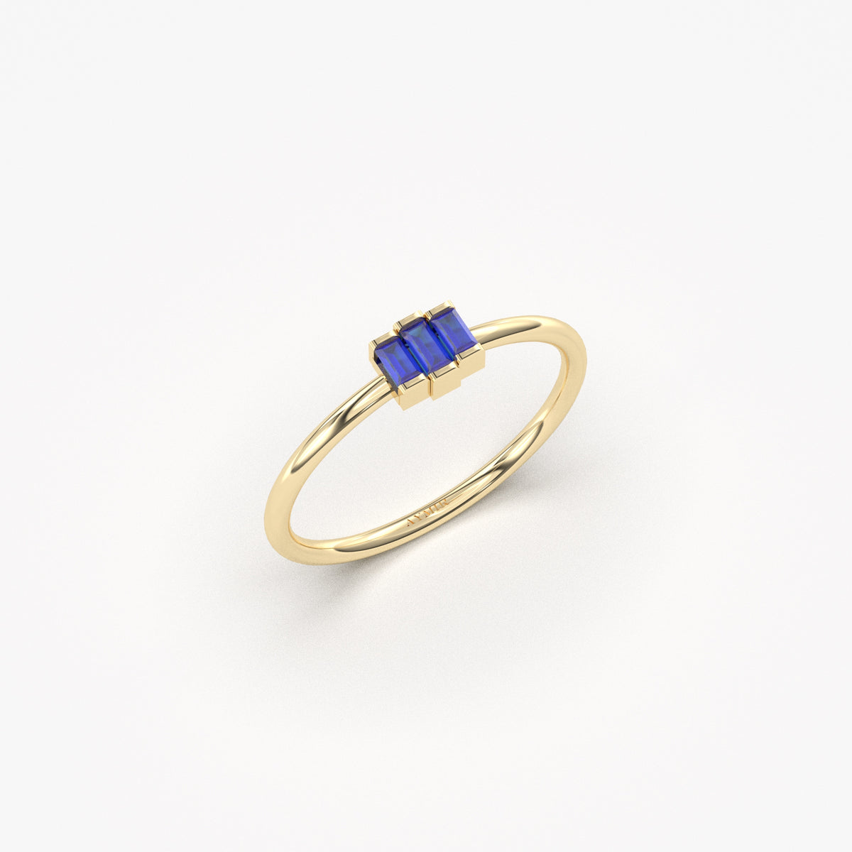 Yellow gold blue-stone three-baguette ring, angled view