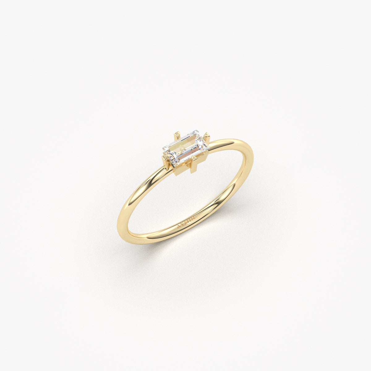 Yellow gold white-stone baguette solitaire ring, angled view