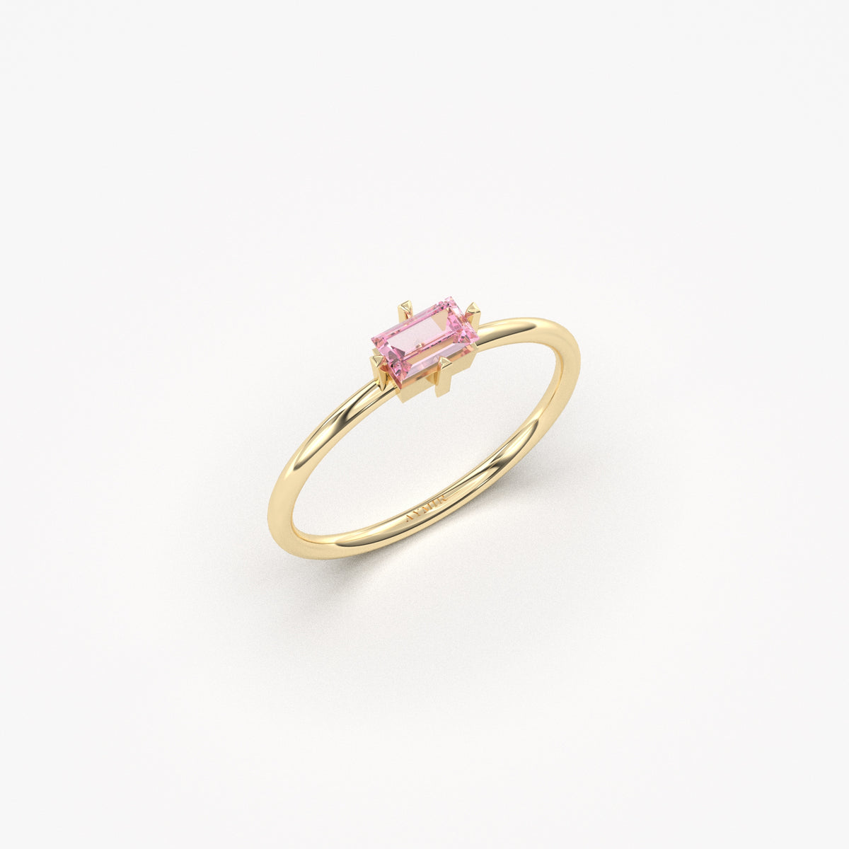Yellow gold pink-stone baguette solitaire ring, angled view
