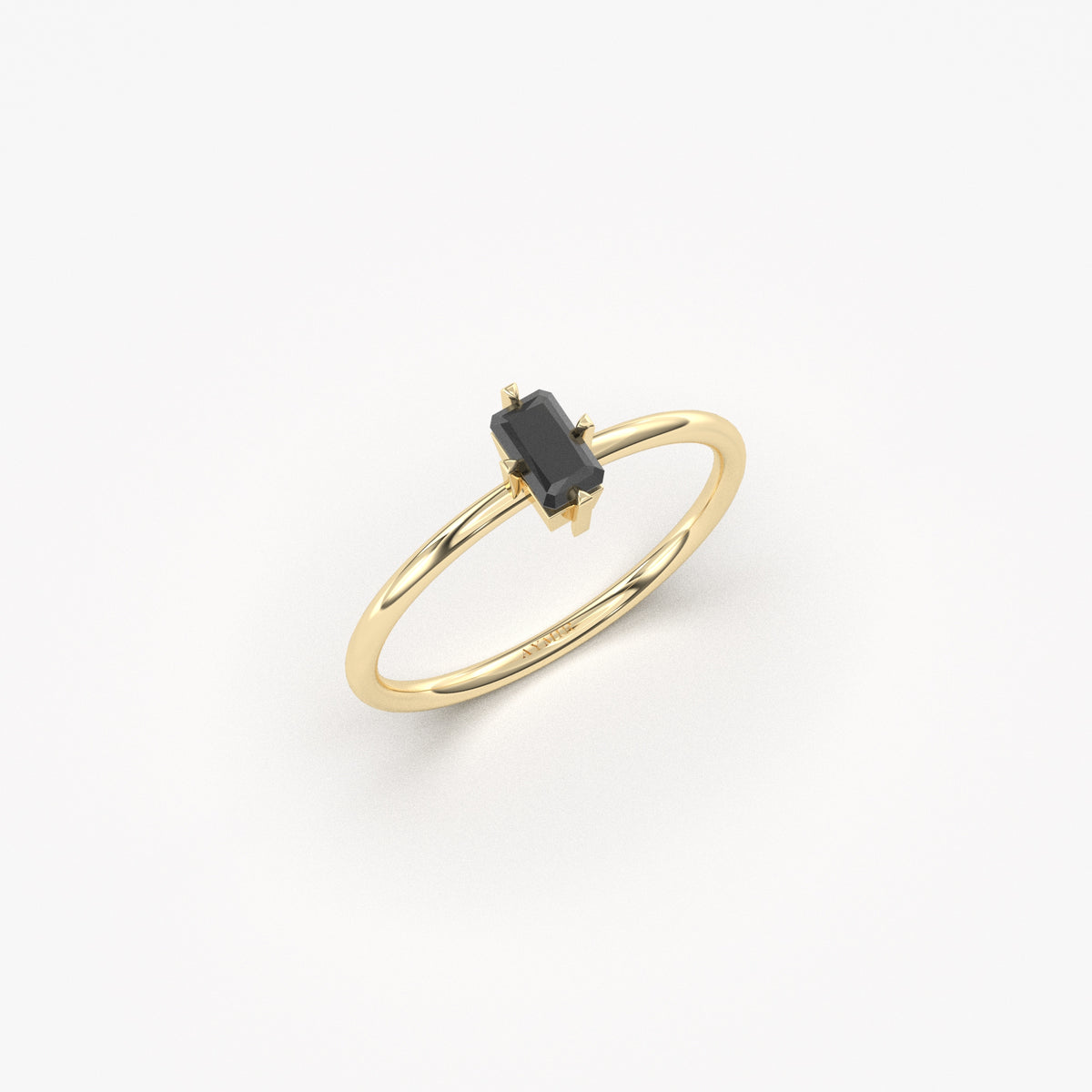 Yellow gold black onyx baguette solitaire ring, angled view