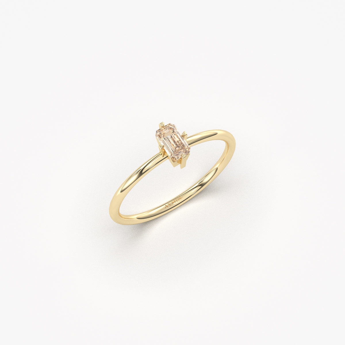 Yellow gold champagne-stone baguette solitaire ring, angled view