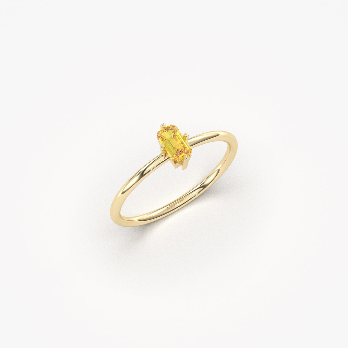 Yellow gold yellow-stone baguette solitaire ring, angled view