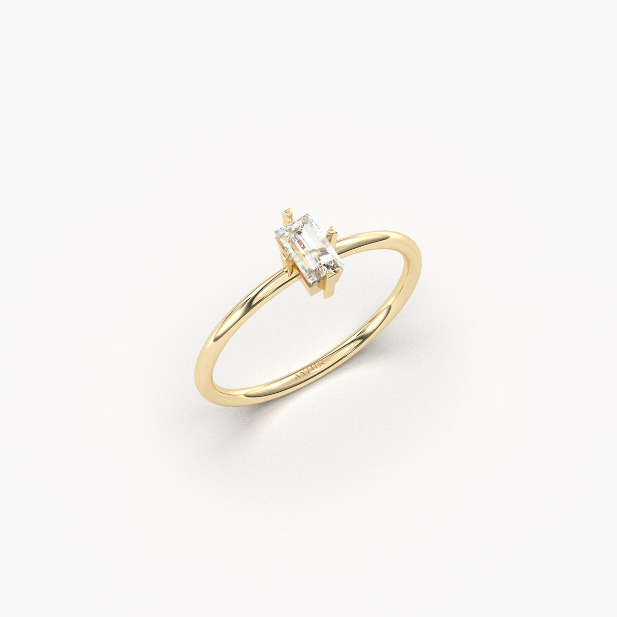 Yellow gold white-stone baguette solitaire ring, angled view