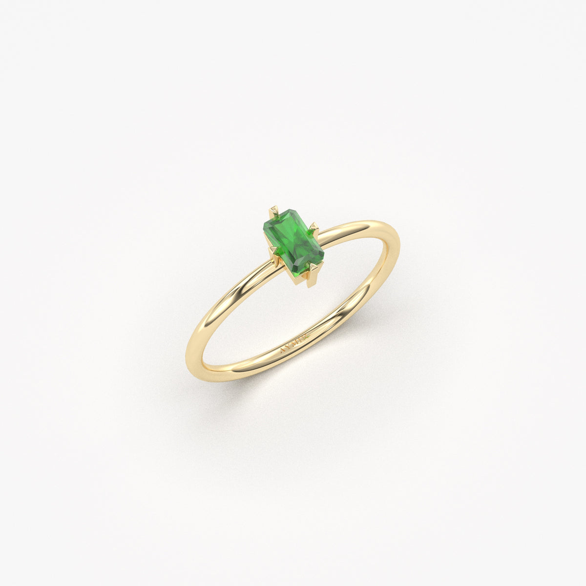 Yellow gold green-stone baguette solitaire ring, angled view