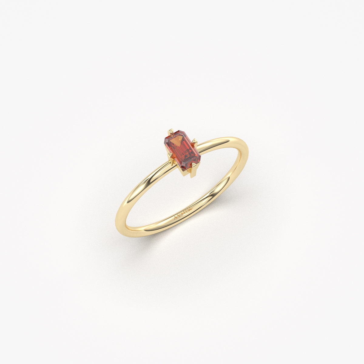 Yellow gold dark-red-stone baguette solitaire ring, angled view