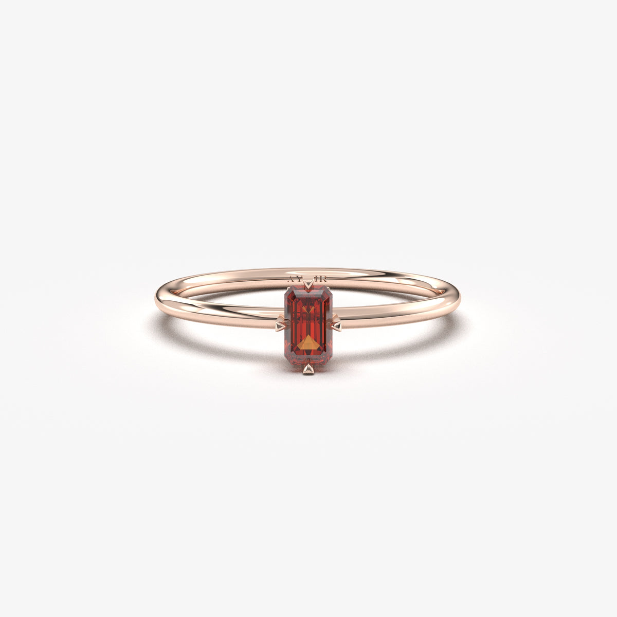 Rose gold dark-red-stone baguette solitaire ring, front view