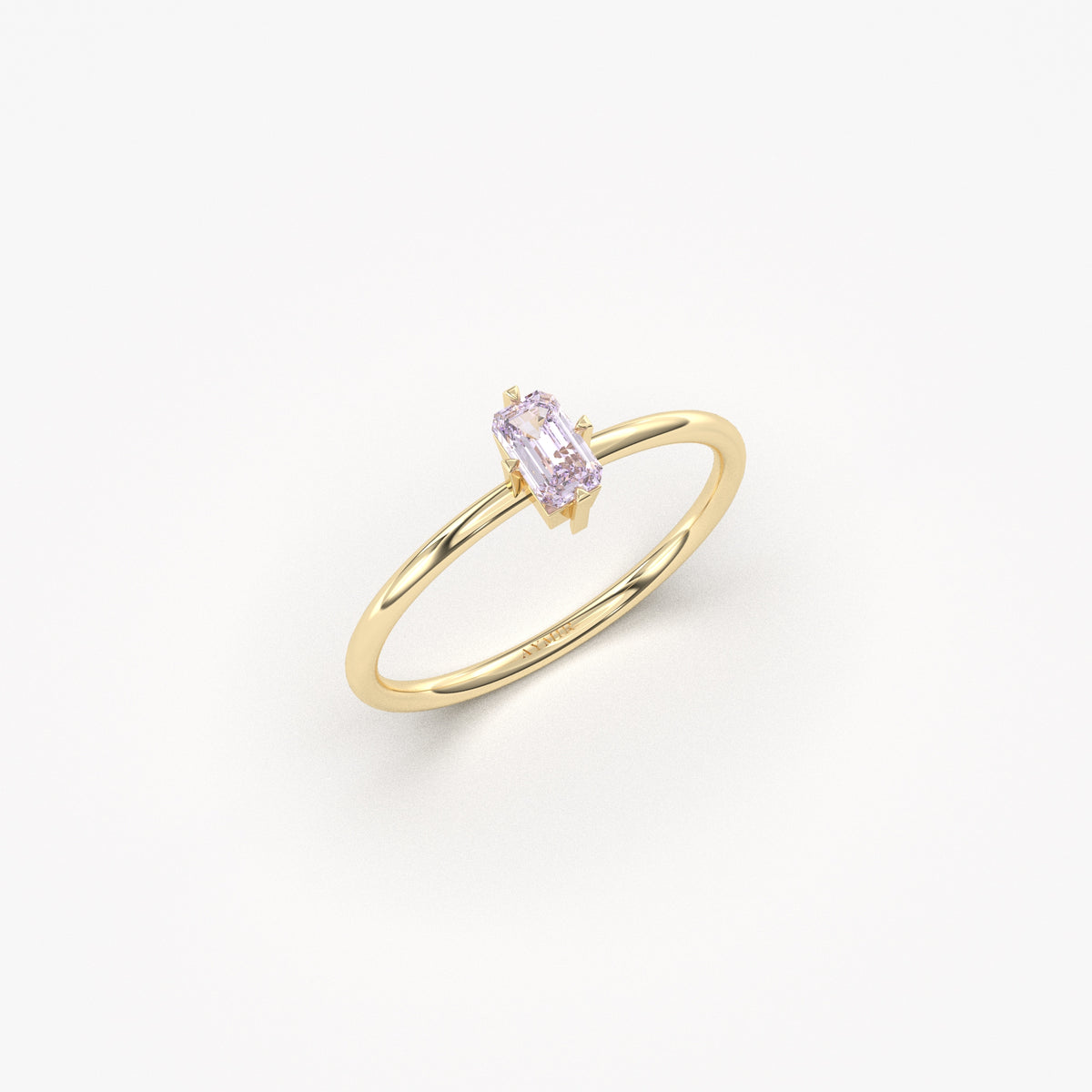 Yellow gold lavender-stone baguette solitaire ring, angled view