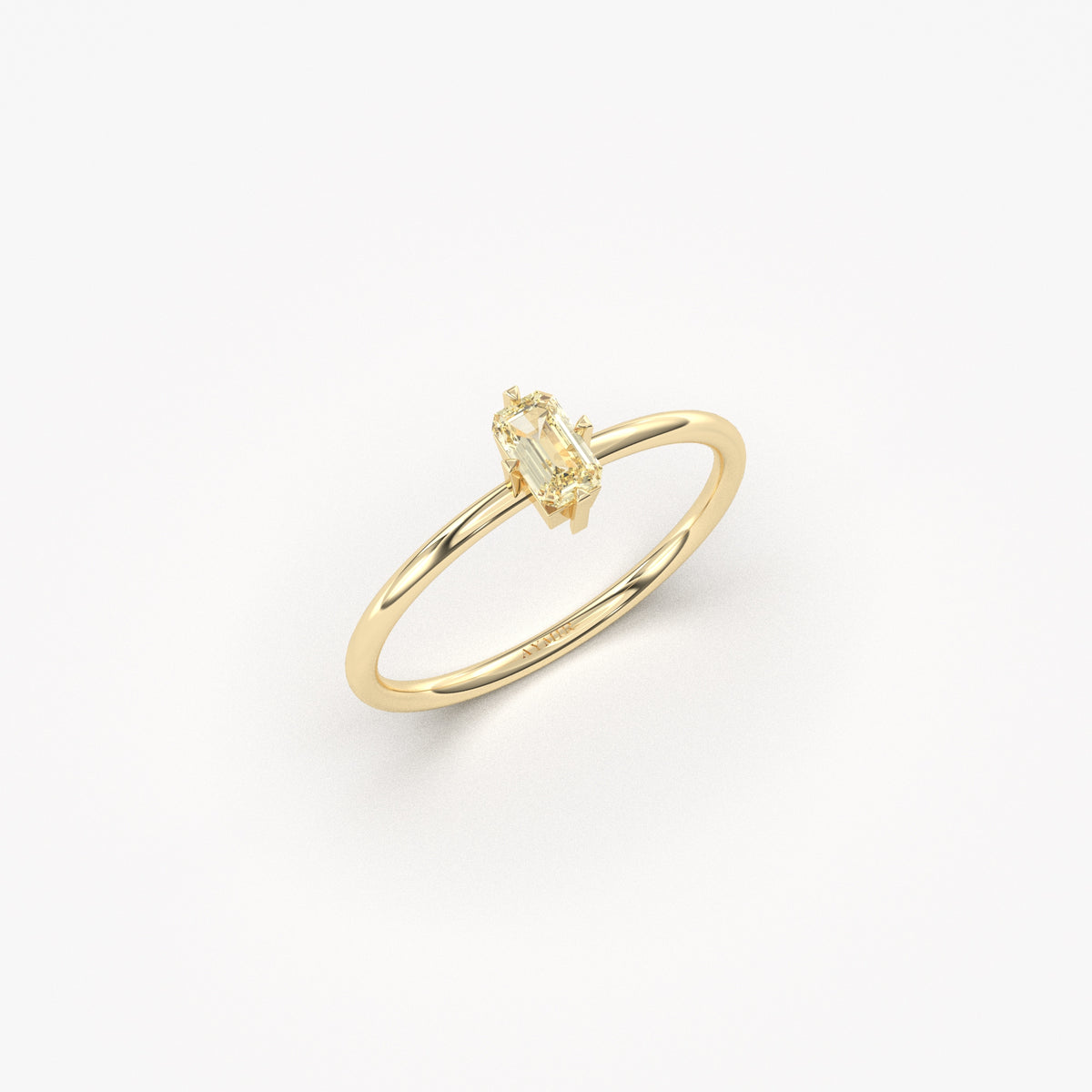 Yellow gold lemon-yellow-stone baguette solitaire ring, angled view