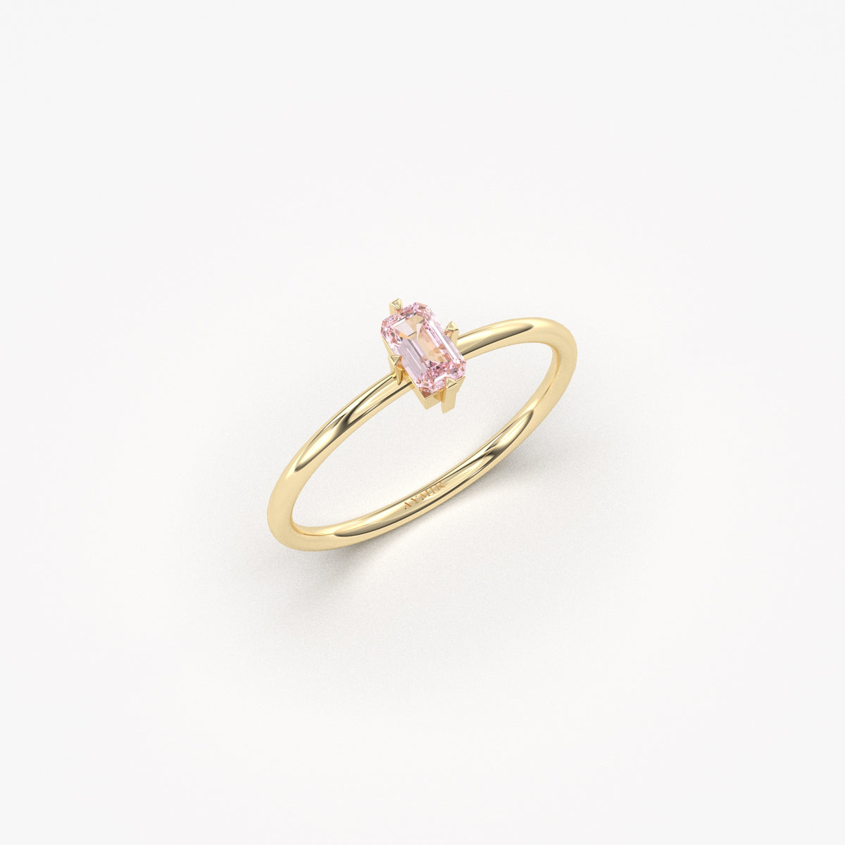 Yellow gold pink-stone baguette solitaire ring, angled view