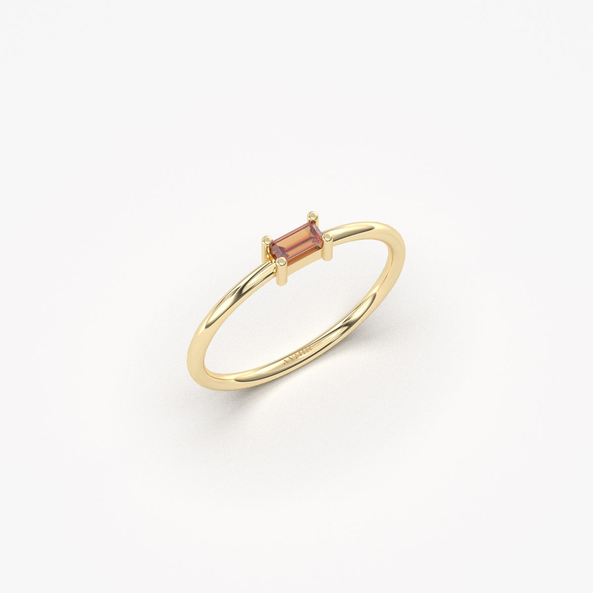 Yellow gold dark-red-stone baguette solitaire ring, angled view