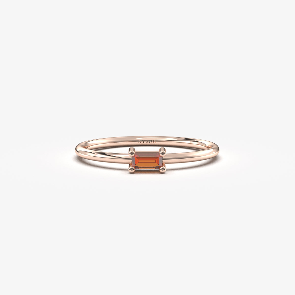 Rose gold dark-red-stone baguette solitaire ring, front view