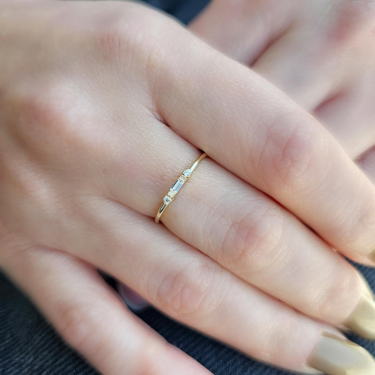 Gold bezel baguette ring worn on hand