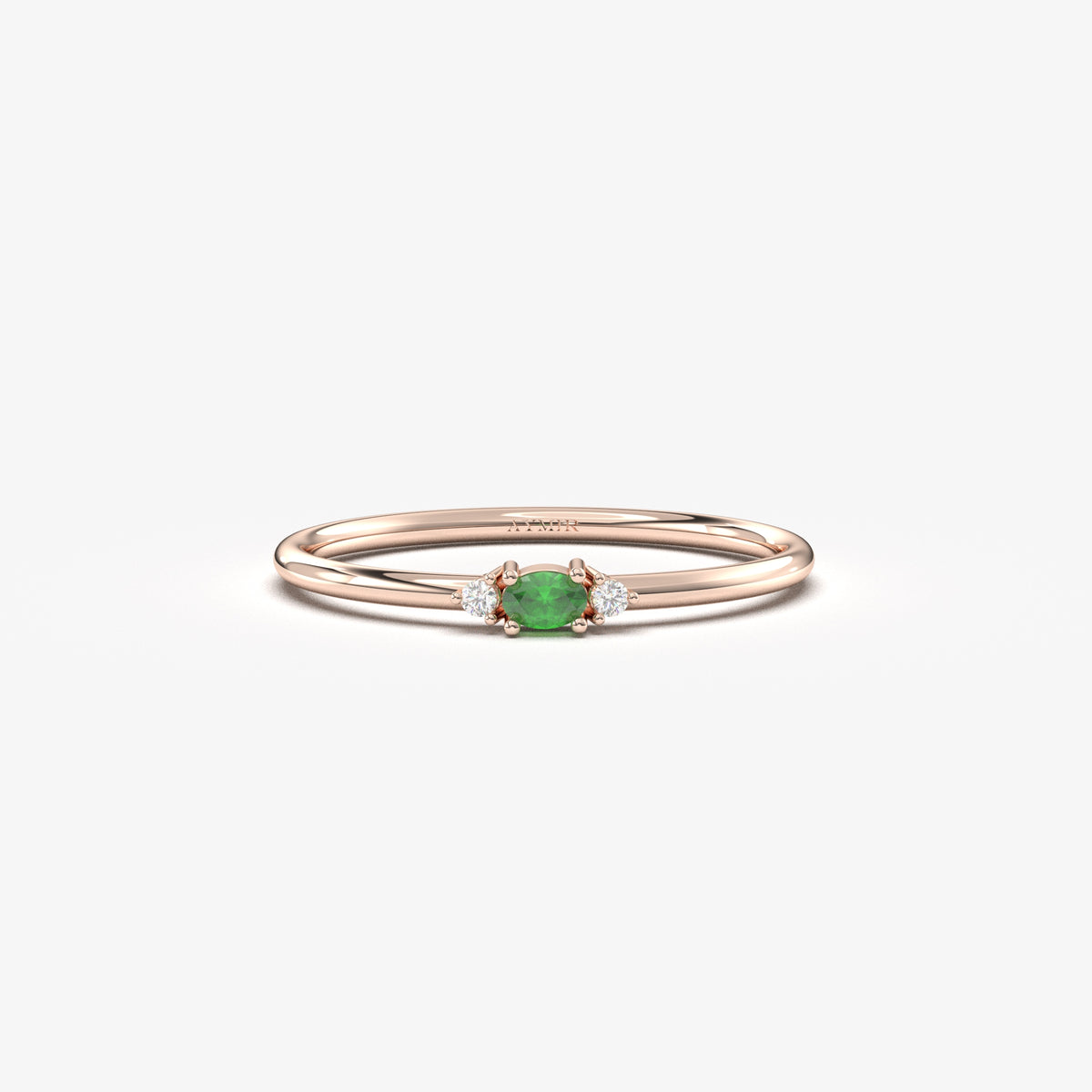 Rose gold green-stone three-stone oval ring, front view