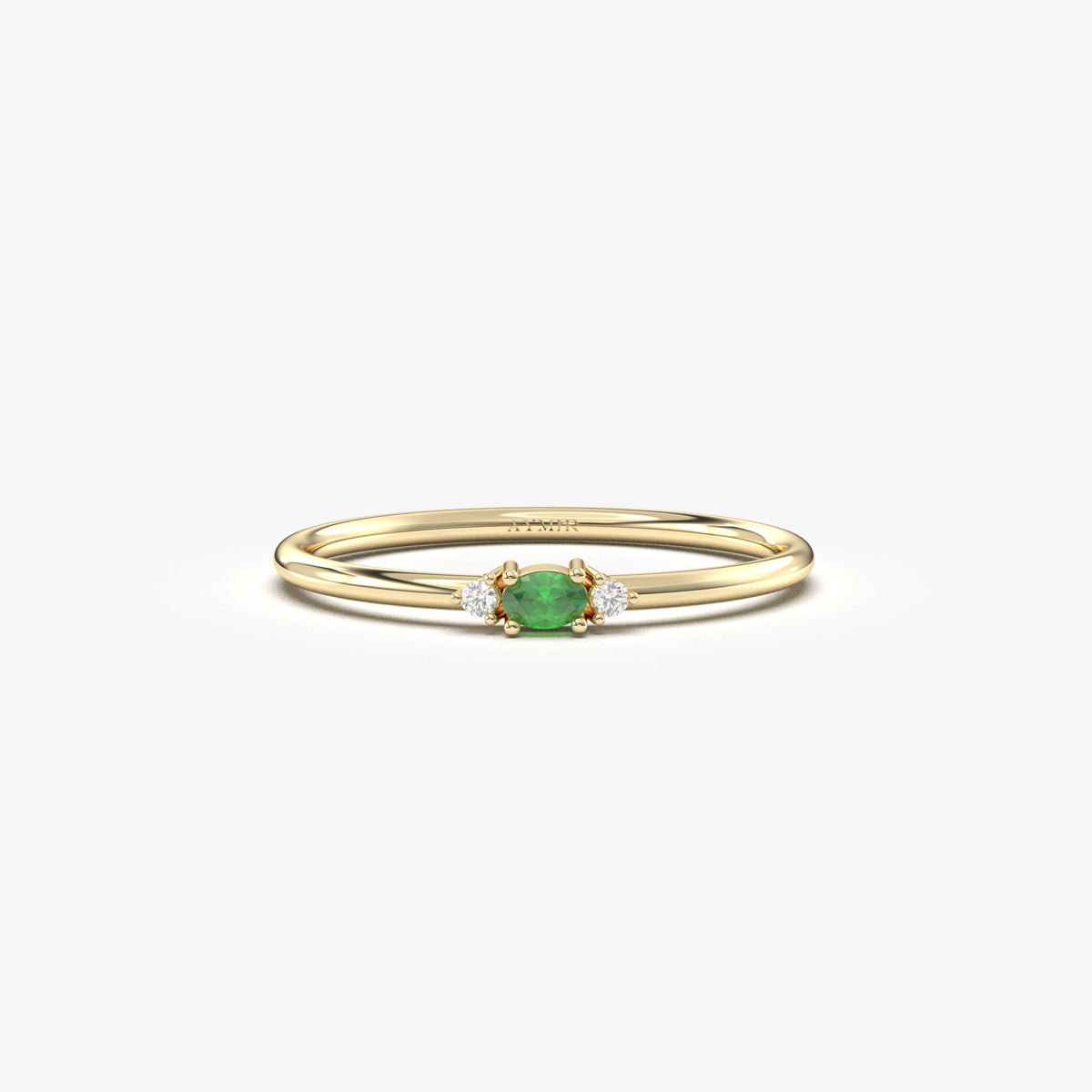 Yellow gold green-stone three-stone oval ring, front view