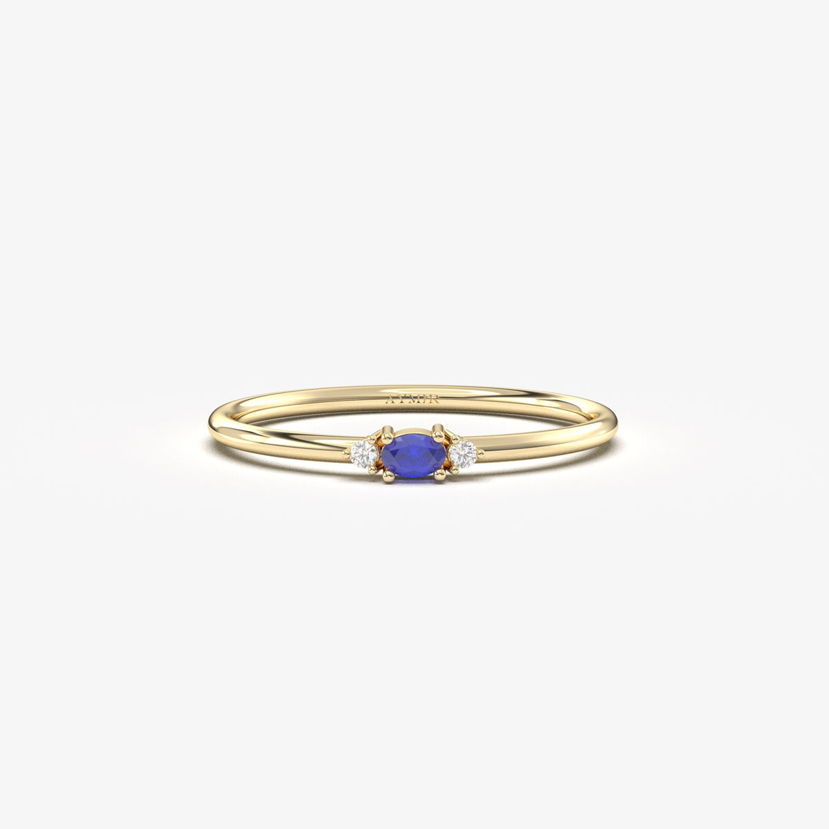 Yellow gold blue-stone three-stone oval ring, front view