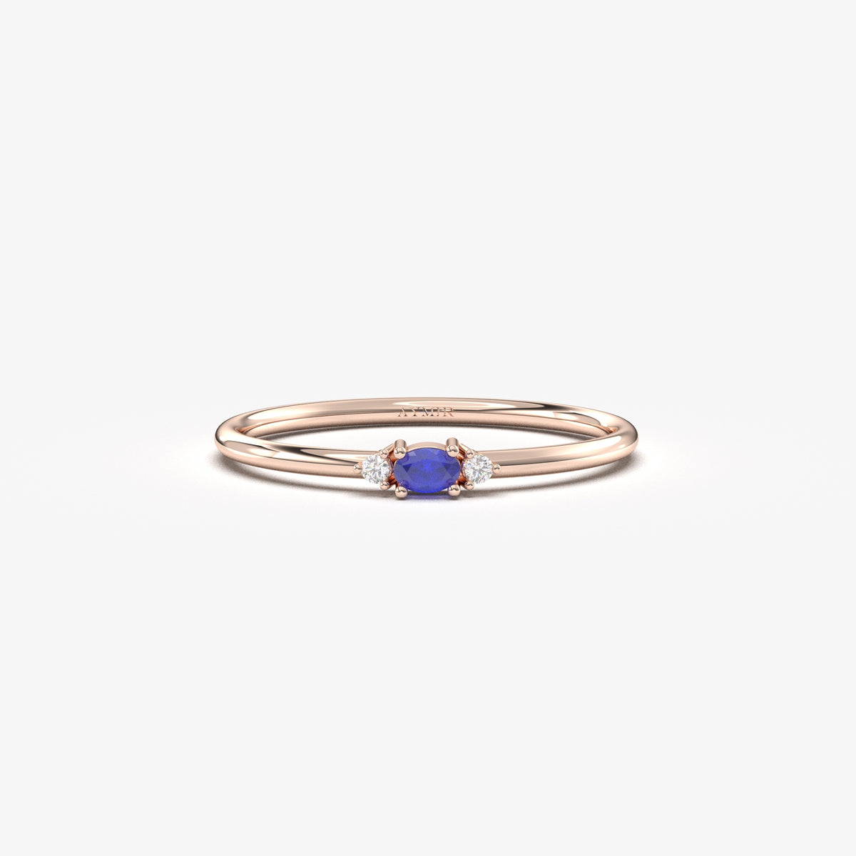 Rose gold blue-stone three-stone oval ring, front view