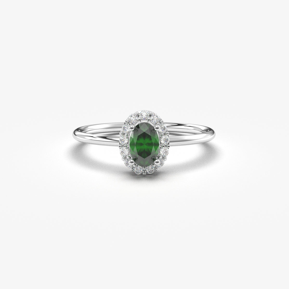 White gold green-stone oval halo ring, front view