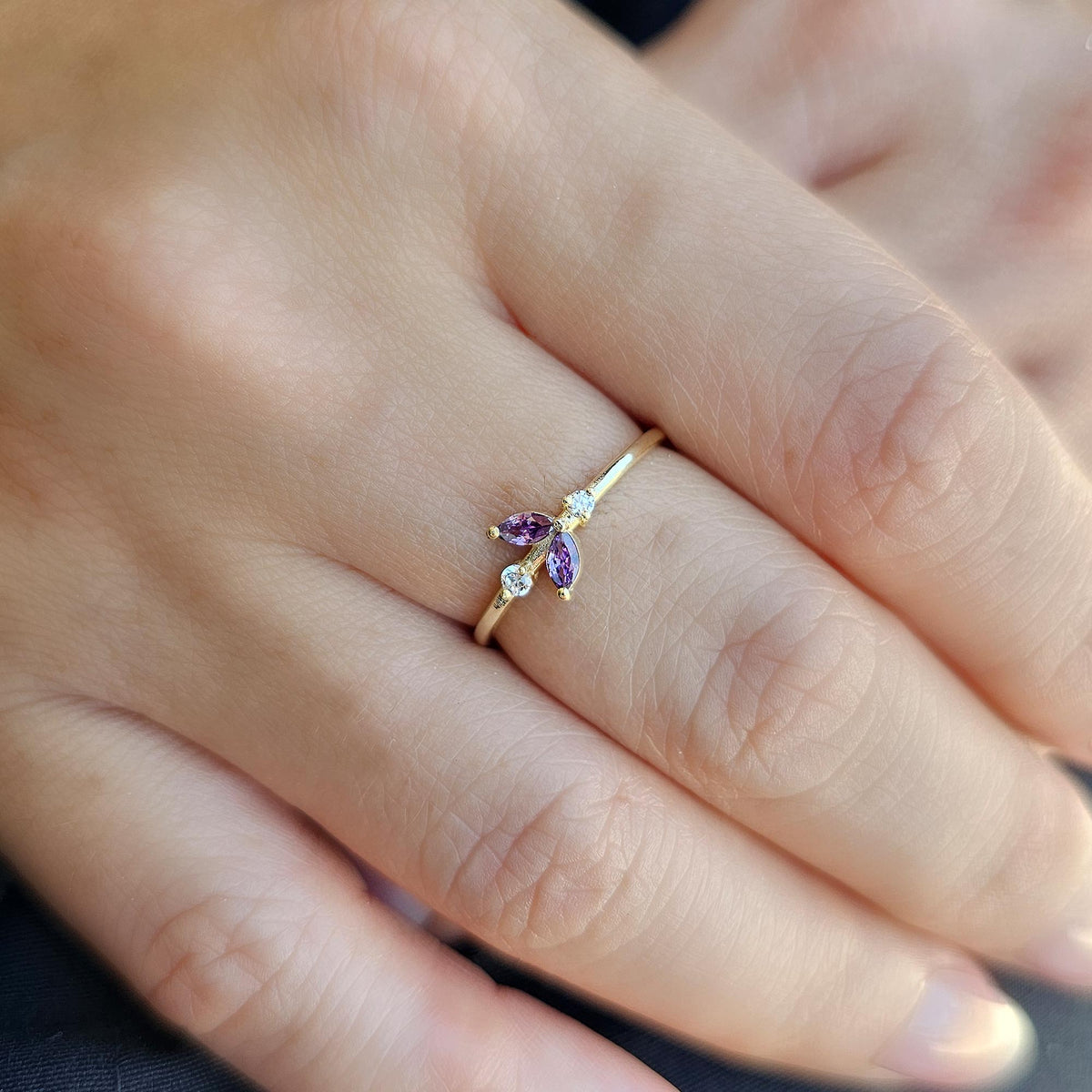 Gold purple-stone marquise leaf ring worn on hand
