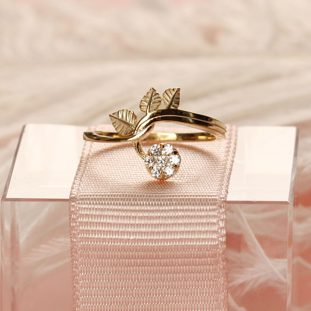 18K gold cluster leaf cubic zirconia ring on display