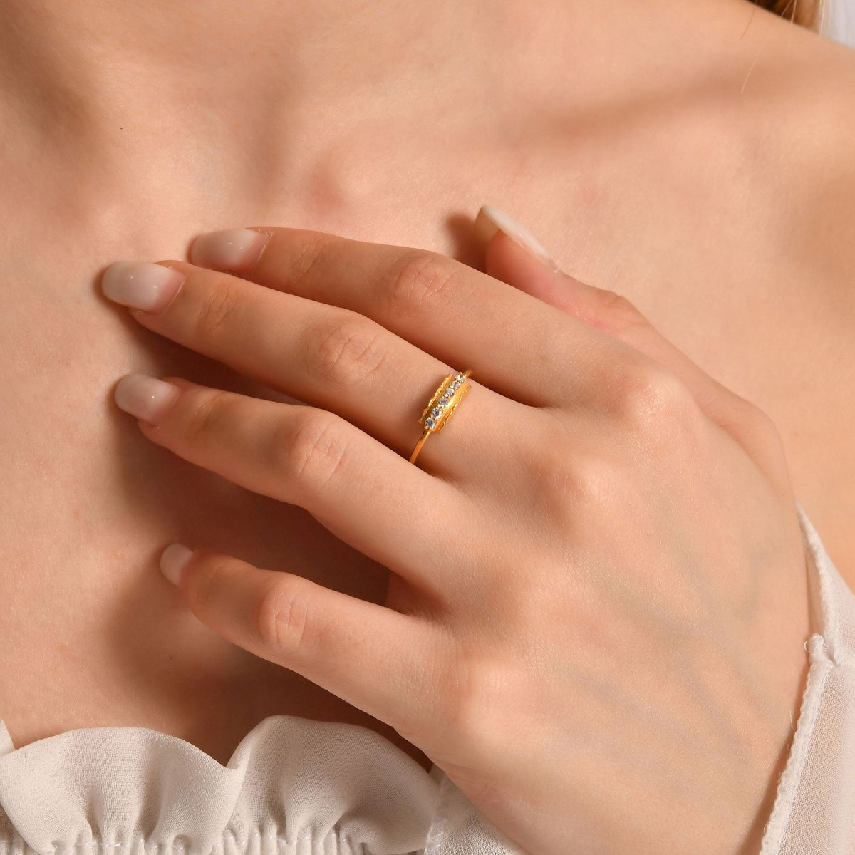 14K gold modern six stone diamond ring on raised hand