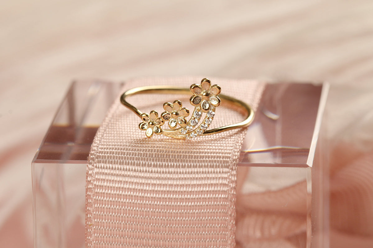 14K gold minimalist flower diamond ring on display