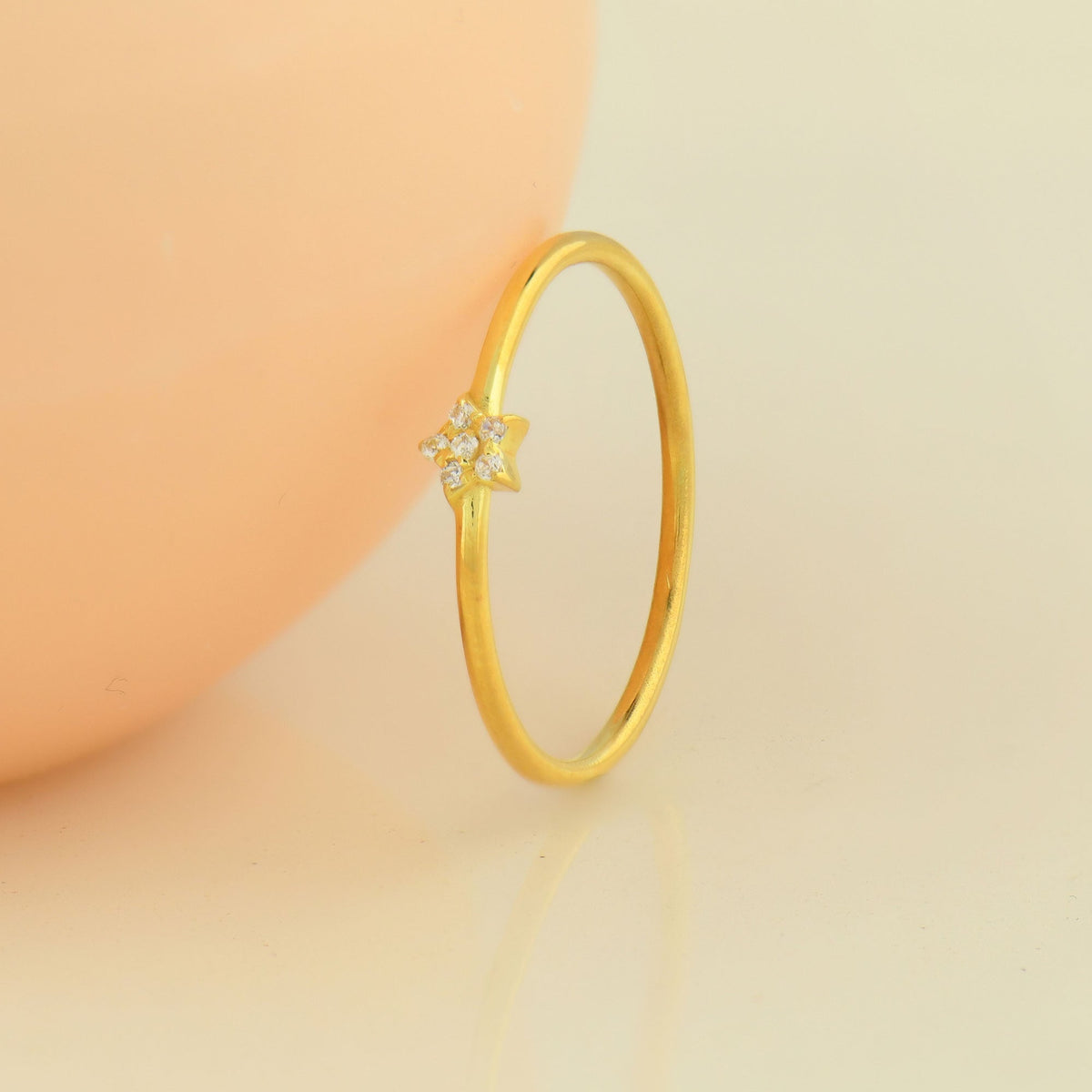 14K gold mini star diamond ring on display